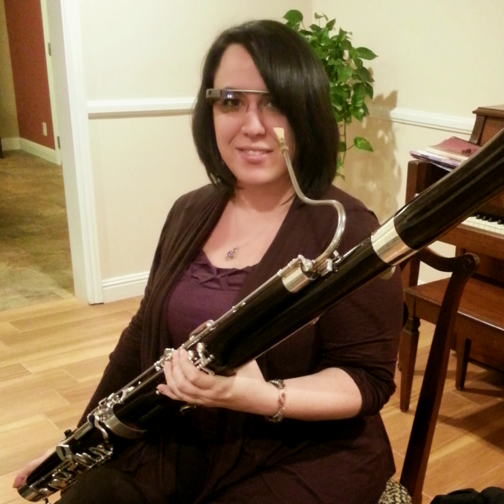 Tracey Siepser holding their bassoon and wearing Google Glass